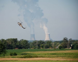 On a non-drought year vacation in Ogle County, you might see our version of an air-show: a helicopter dusting crops set against a back drop of the nuc plan on the skyline. An image of a helicopter in Stillman Valley.